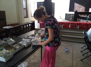 Pam works hard sorting reading glasses for the hundreds that need them.
